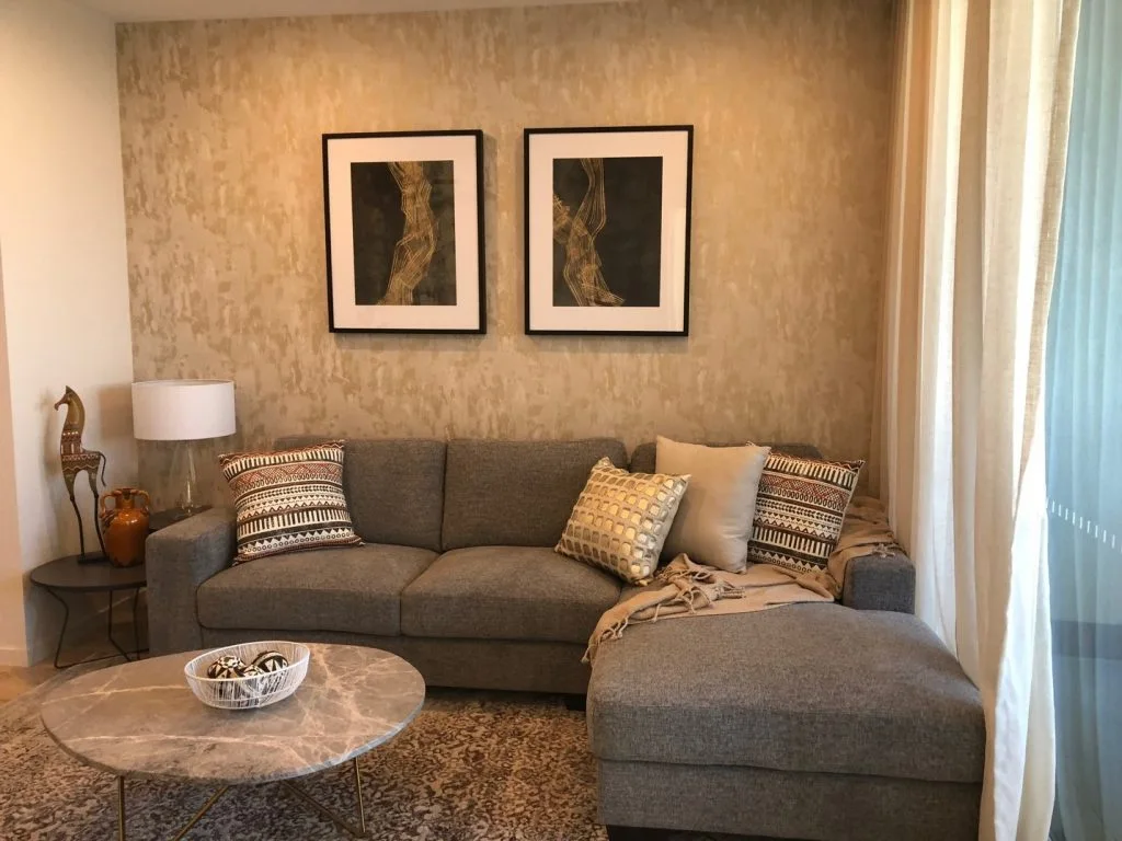 Stylish living room interior with gray sofa, marble table, and modern art. Furniture hire Perth concept.